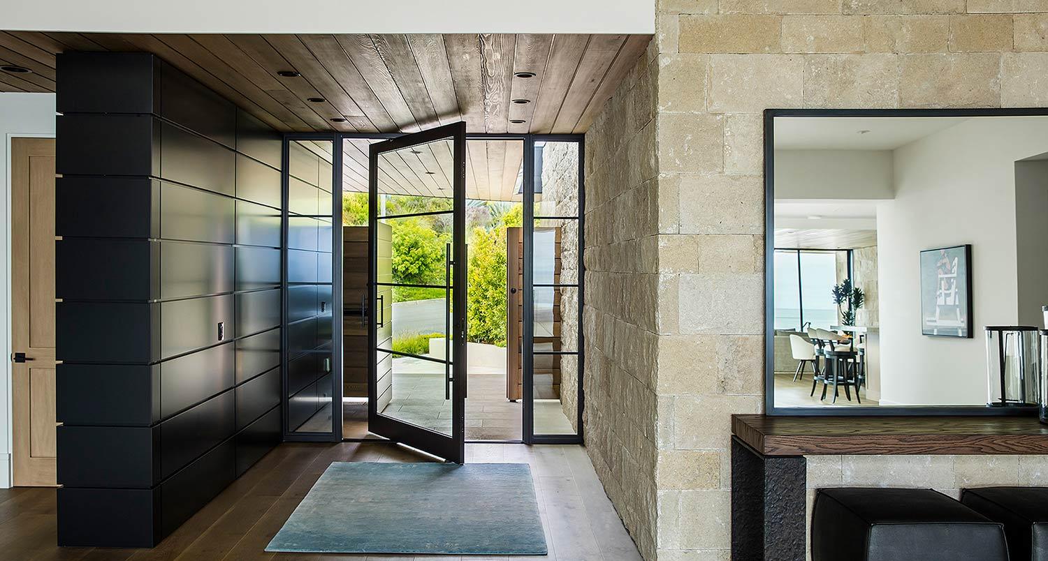 Modern home entrance with open pivot door