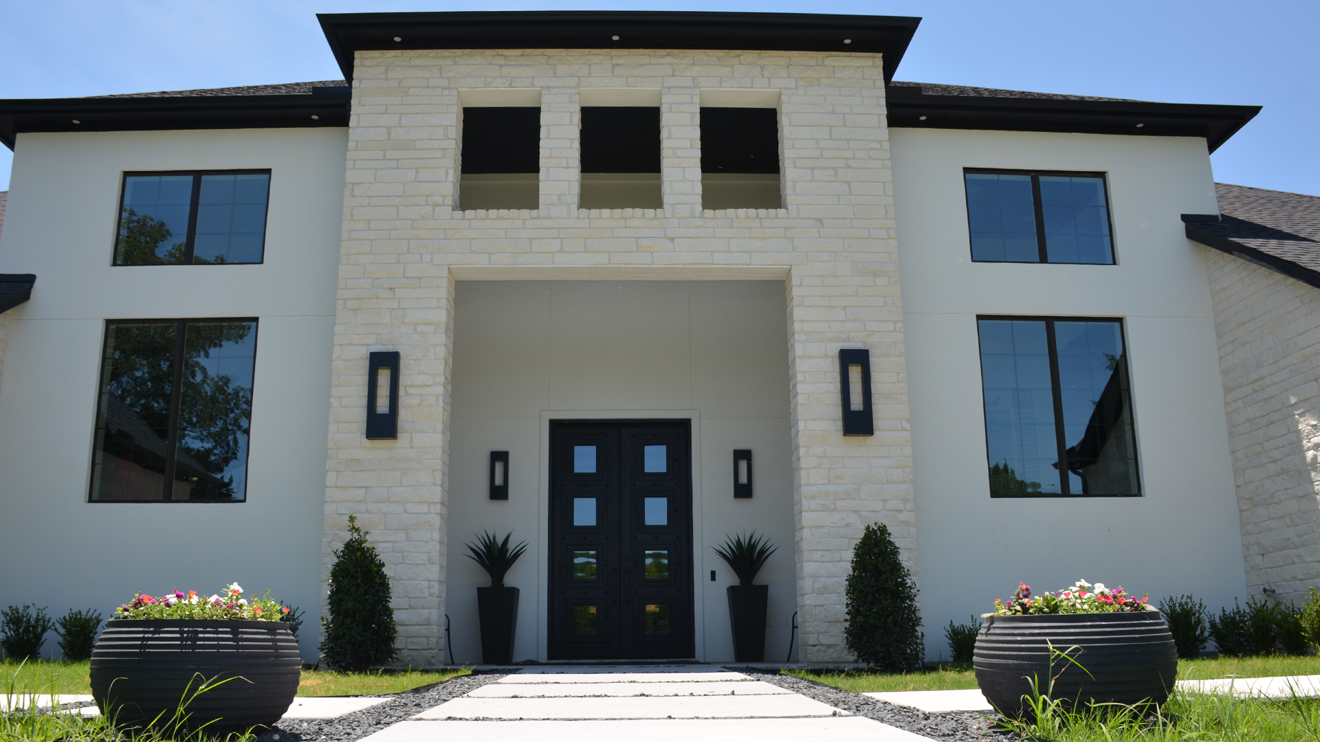 Modern stone house with black double doors