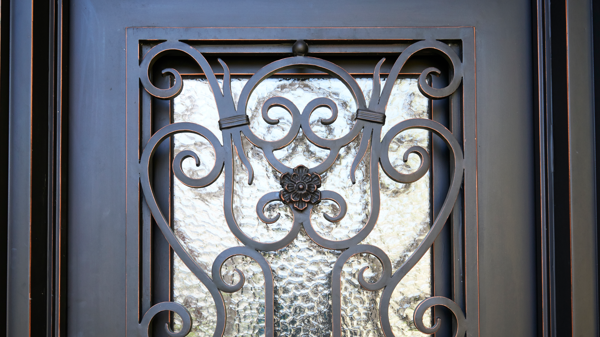 Ornate wrought iron door with floral design