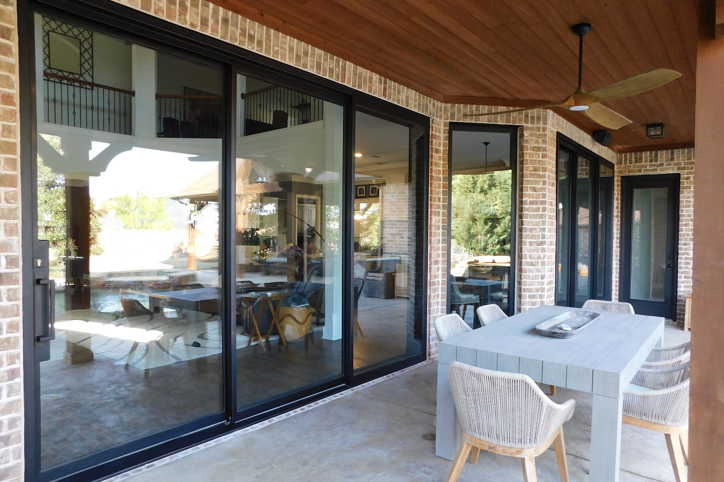 Modern patio with large glass doors and table