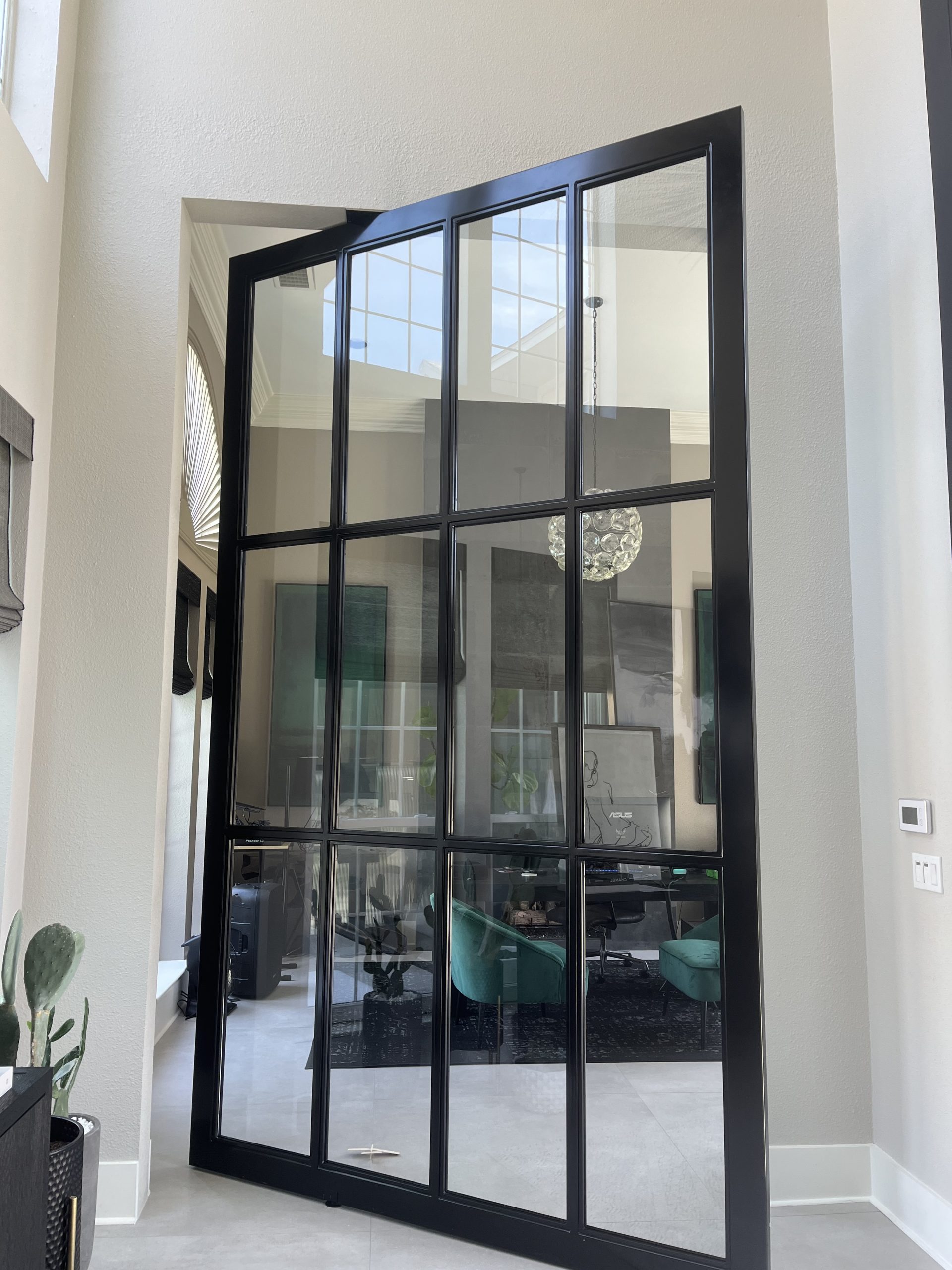 Tall glass door with black frame in office