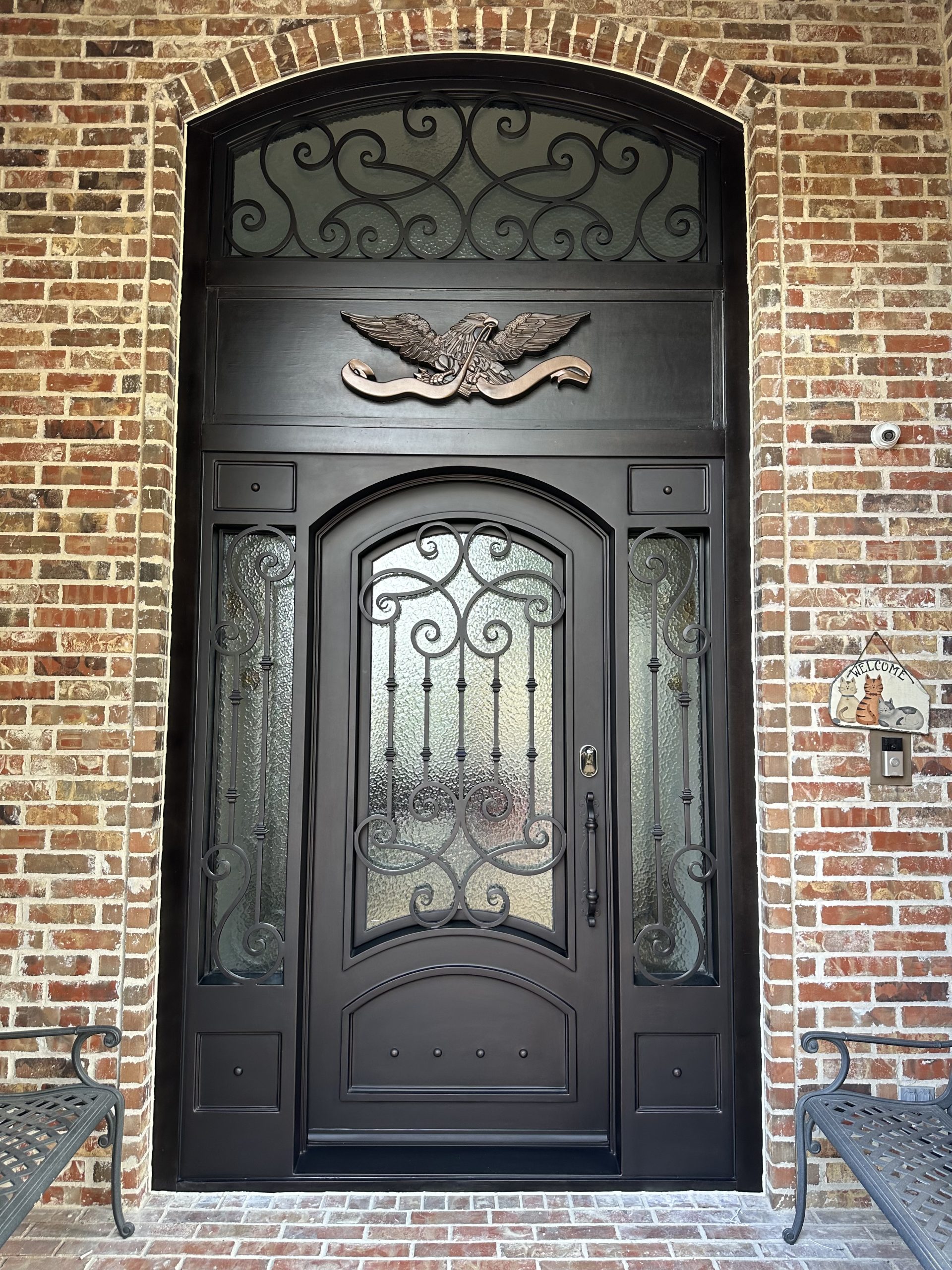 Elegant black wrought iron front door with glass.